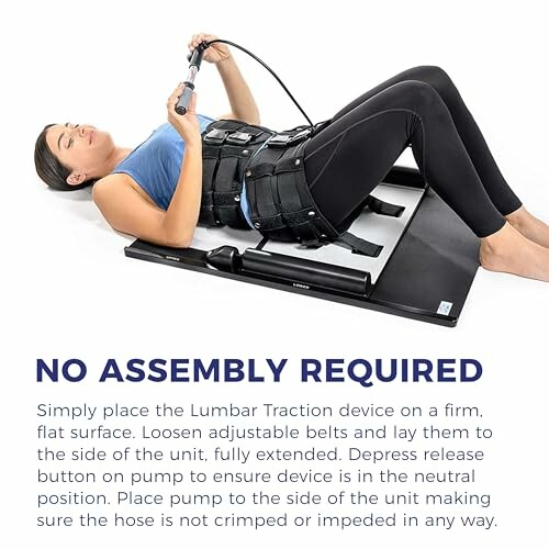 Woman using a lumbar traction device on a flat surface.