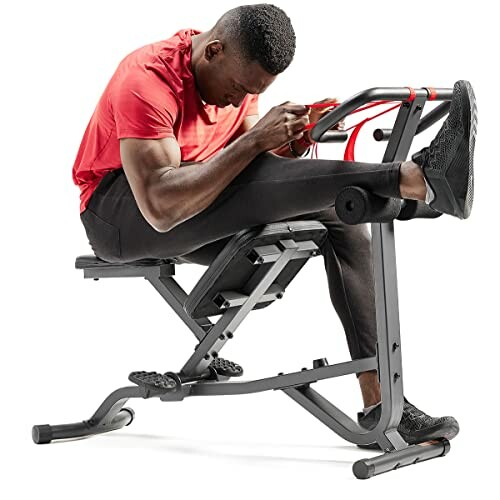 Man using exercise machine for fitness workout.